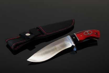 Coltello a lama fissa con impugnatura in vero legno rosso e fodero in Cordura nera su sfondo scuro con piano a specchio